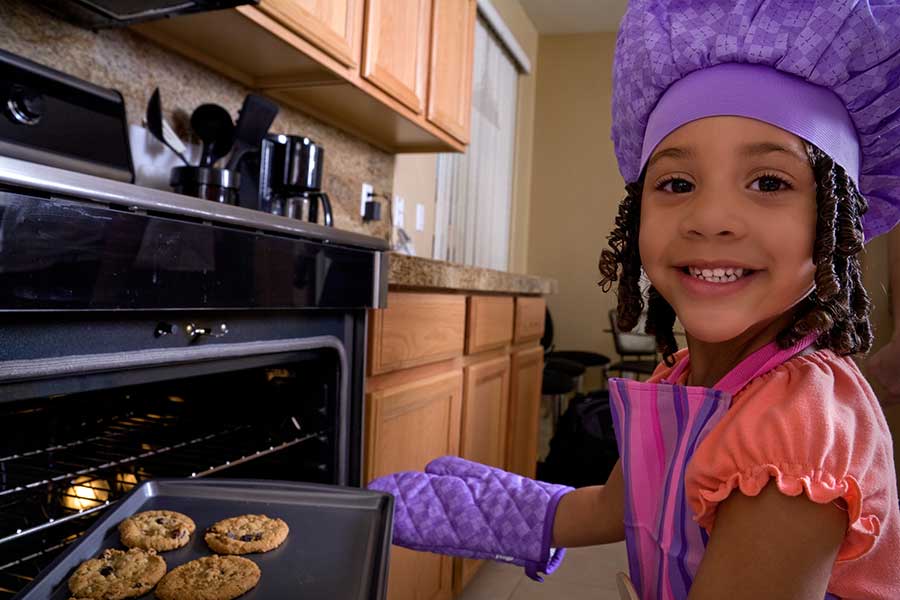 young girl baking cookies
