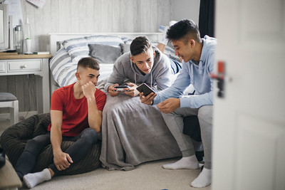 Teen boys look at phone