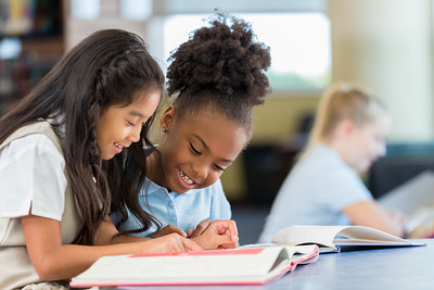 Two girls studying together