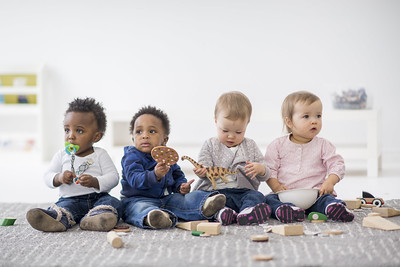 Children sitting on a carpet together