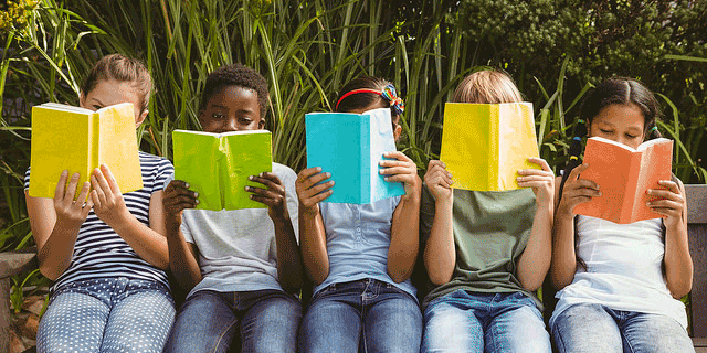 A group of students sitting together while reading books