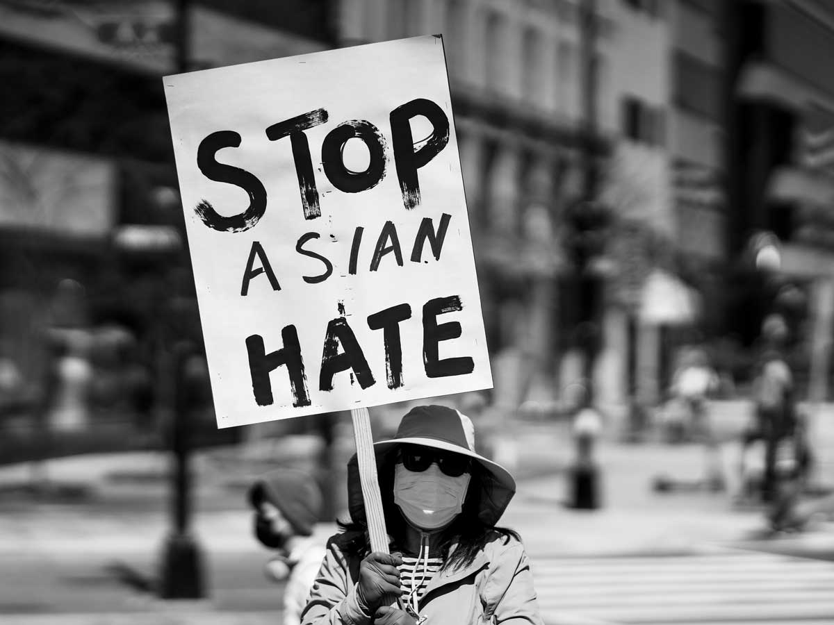 Stop Asian Hate photograph by Miki Jourdan. Blacka and white photo of woman holding sign that says Stop Asian Hate. DC Rally for Collective Safety; Protect Asian/AAPI Communities; McPherson Square, Washington, DC.