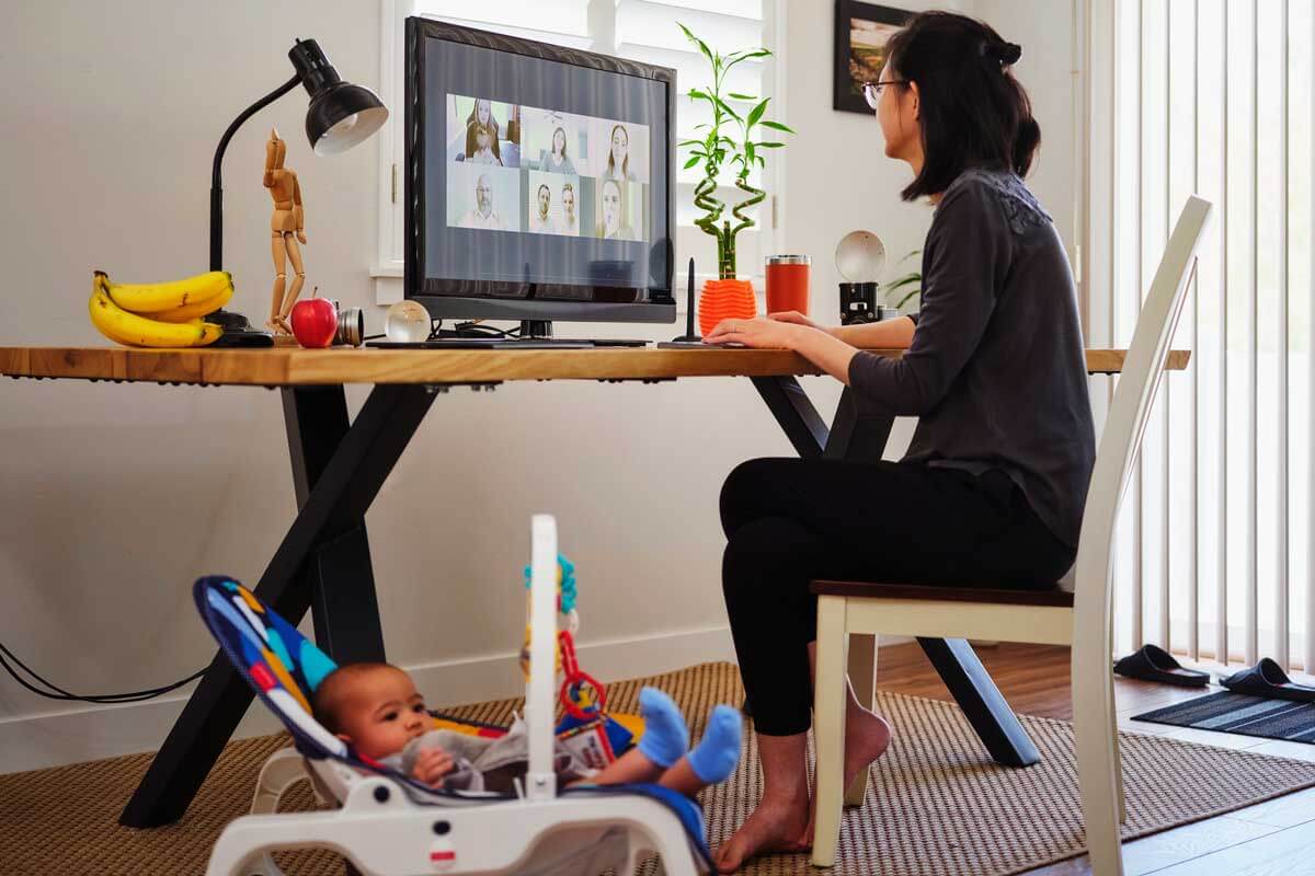 Mom works from home while caring for her child