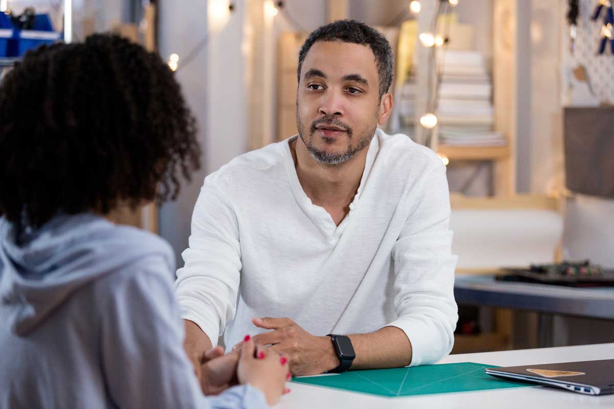 adult and teen in serious conversation