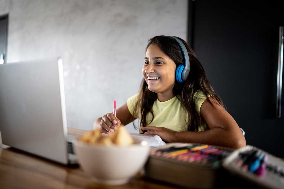 middle school girl doing remote lesson with laptop