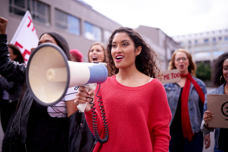 Women marching with a loudspeaker