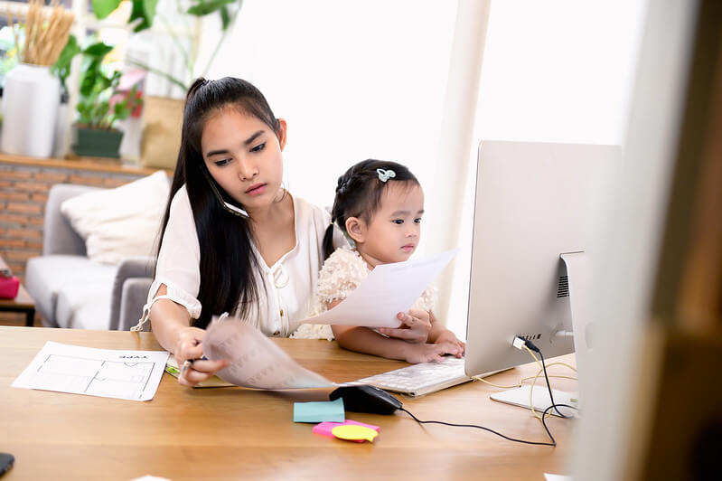 Woman taking care of child while working