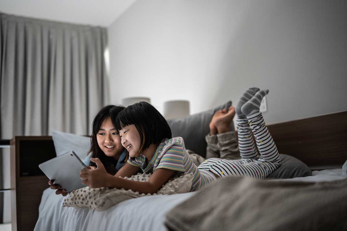 Asian teen girls using tablet