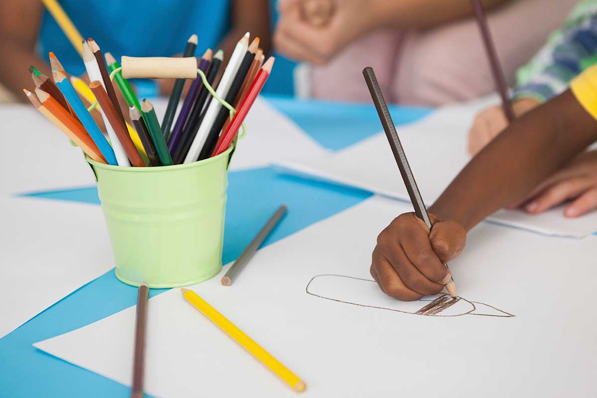 arm of a child drawing a picture