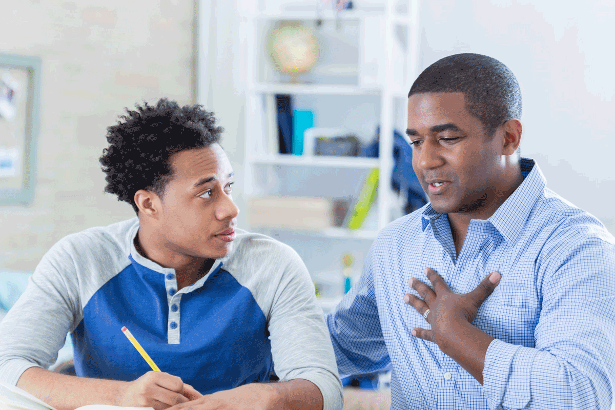 Black father and son in conversation