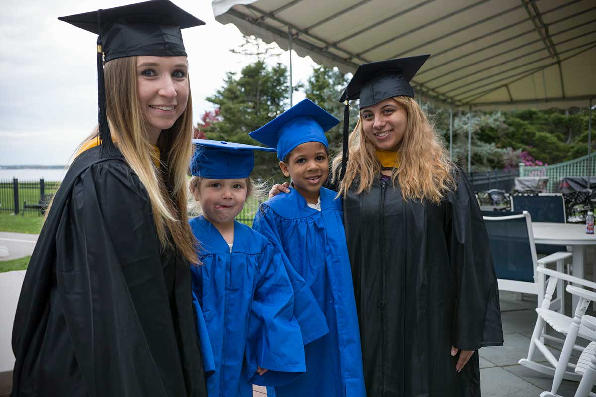 Anna Grimes and her daughter Audrey, and Esraa Amira and her son Jaden celebrate their graduation at Endicott College in 2017.
