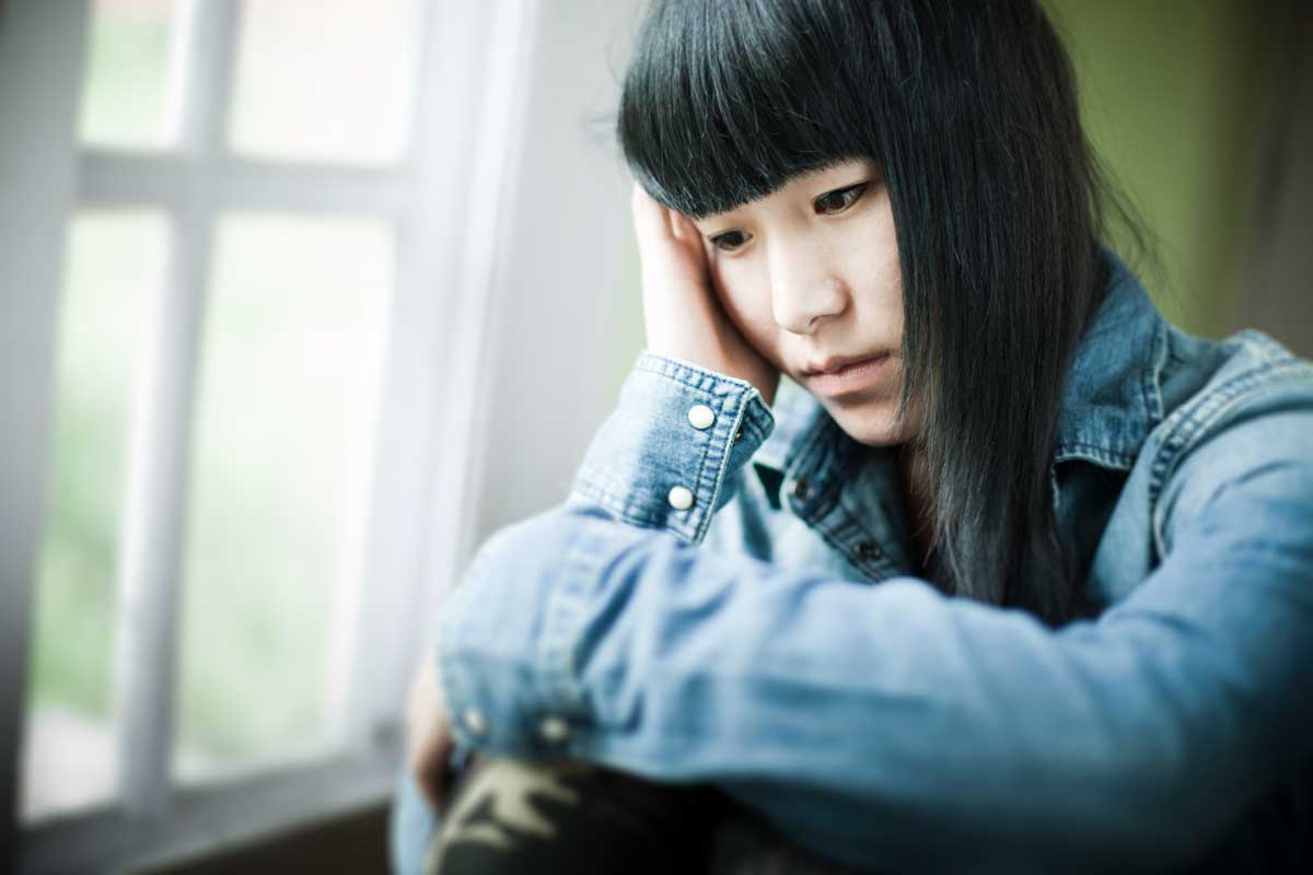 Sad Asian teen girl.